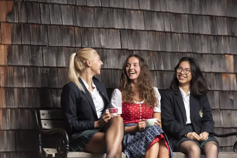 Students talking in the courtyard at St. Gilgen International Day and Boarding School