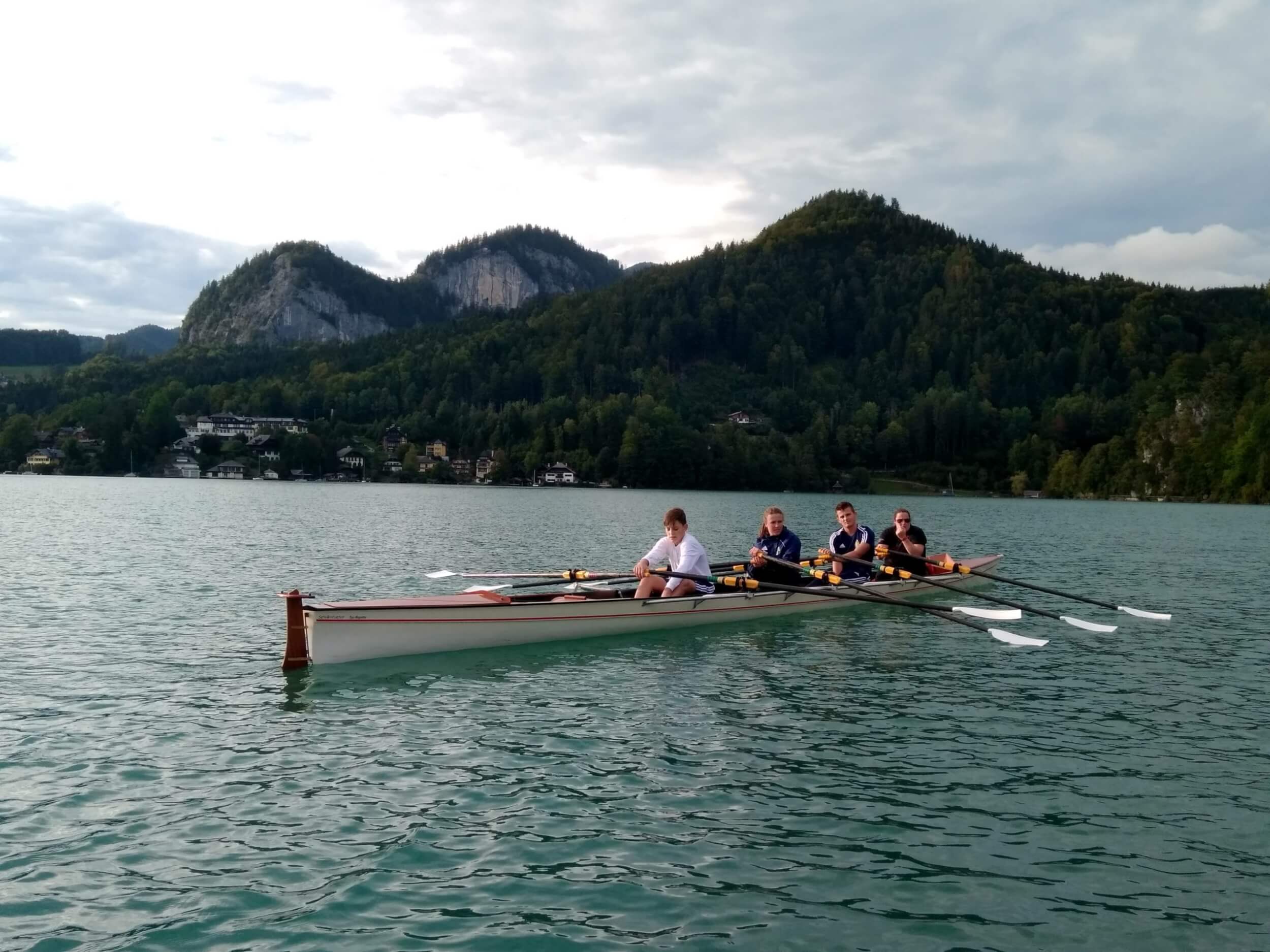 Students participating in a rowing activity on Wolfgangsee near St. Gilgen International Day and Boarding School