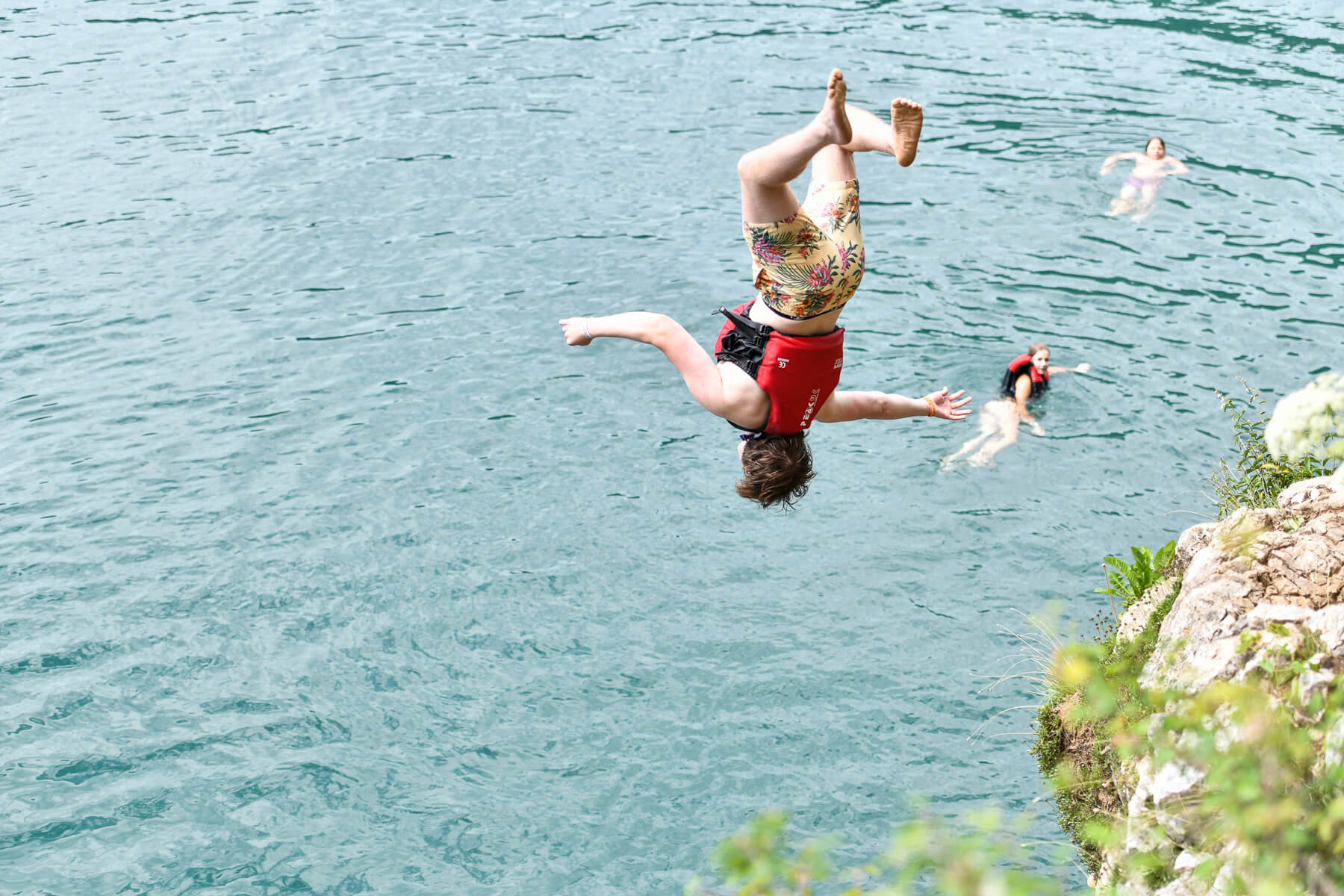 Students taking part in a cliff jumping challenge during the DARE Race at St. Gilgen International Day and Boarding School