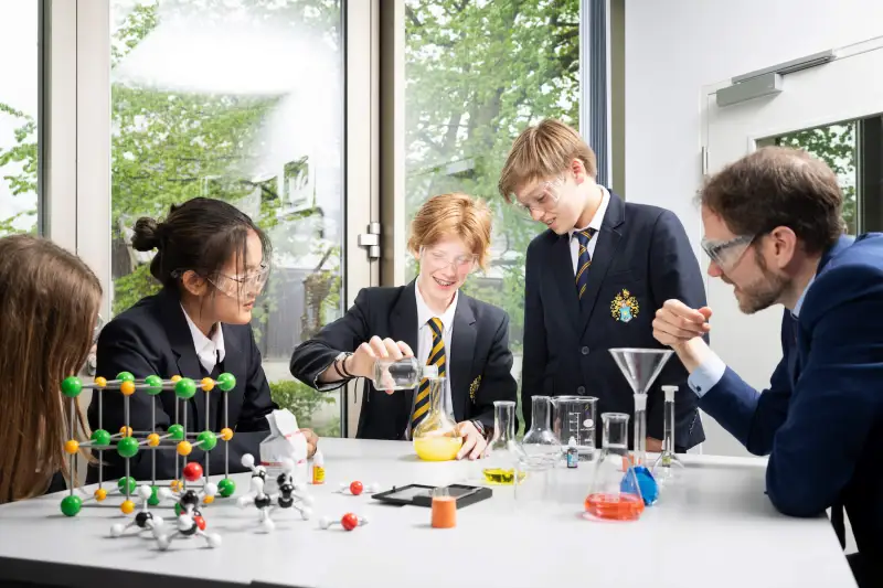 Students in a chemistry class at St. Gilgen International Boarding School with views of the Austrian Alps